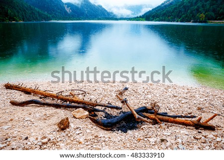 Campfire on the shore of Lake. Lake with mountain in summer rain.