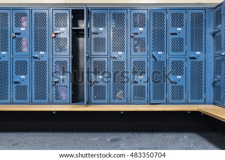 Blue cage lockers in a gym with a bench in front  Royalty-Free Stock Photo #483350704