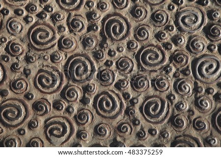 Metal spiral pattern. Metallic bronze background with textures and patterns