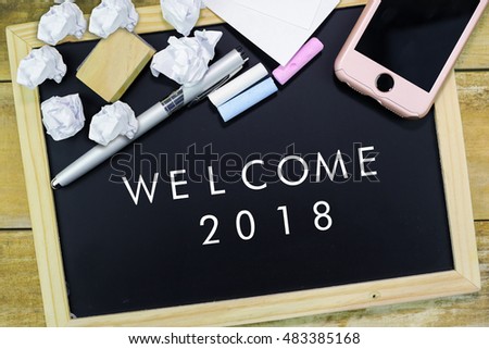 Welcome 2018 from keyboard button with shiny world background

