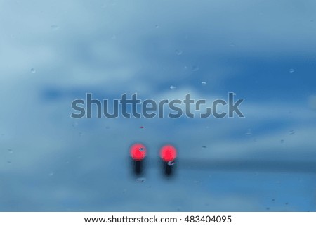 Image of traffic lights while red light on. Cloudy sky background