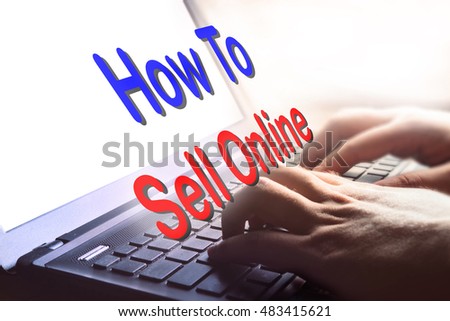 How To Sell Online text on hand typing on laptop.