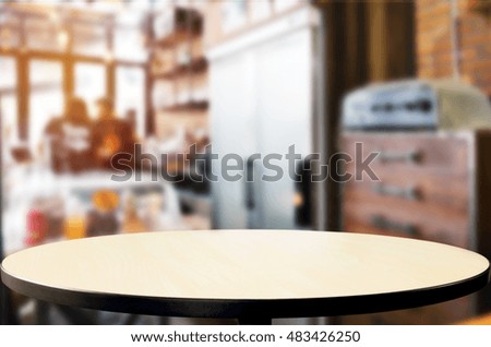 Selected focus empty brown wooden table and Coffee shop blur background with bokeh image, for product display montage