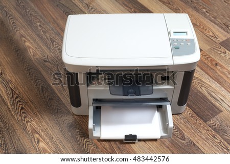 Domestic printer on wooden background
