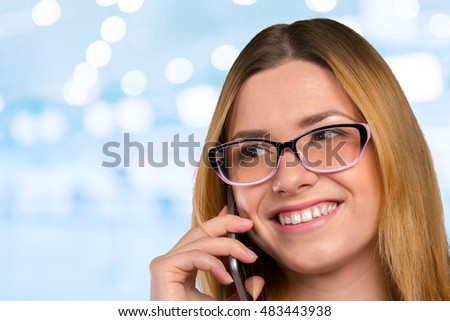 Young happy caucasian woman is calling with a mobile phone
