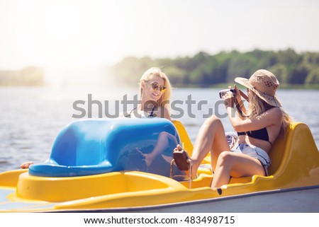 Girl taking a photo of her friend