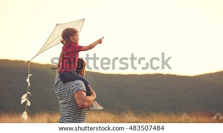 happy family father and child on meadow with a kite in the summer on the nature