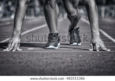 Sport. Unrecognizable runner on the starting -- selective focus, toned and stylized photo