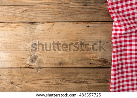 Checkered tablecloth red on the wooden background/ texture