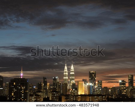 An enhance Photo of Kuala Lumpur cityscape during blue hour with strong blue and orange color in the back drop