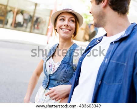 Happy young couple walking in city