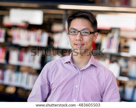 Happy male student at the library