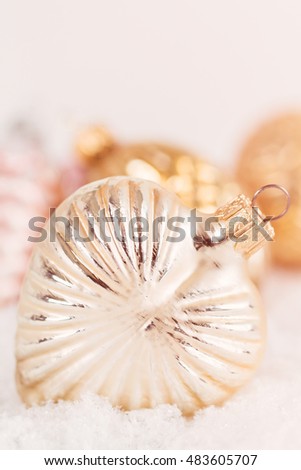Closeup antique style glass Christmas decorations on snow background. Shallow focus