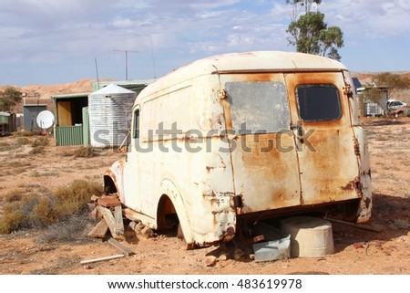 Rusic vintage car wreck, water storage tank and satellite dish in ghost mining town, South Australia