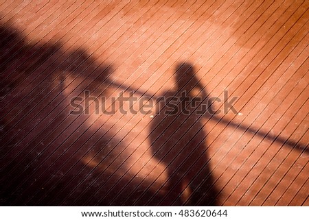 People shadow with reflection on the ground
