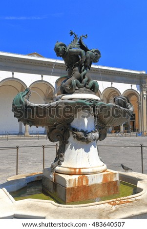 Sea monsters decorate a fountain in front of the Basilica della Santissima Annunziata in Florence, Tuscany, Italy