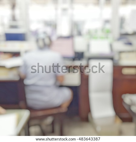 Blur abstract background nurses in white uniform working behind nurse station counter in patient's wards hospital:Blurry interior perspective view staff team on duty in charge of clinical routine job.