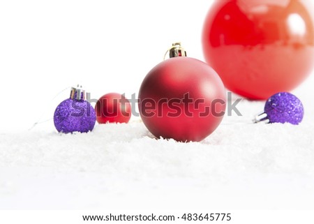 Christmas Decoration with Balls in the Snow on the Blurred Background of Bright Holiday Lights. Greeting Card