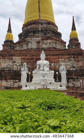 The Buddha statues with the background of Ancient pagoda at Wat Yai Chaimongkol, Ayutthaya, Thailand