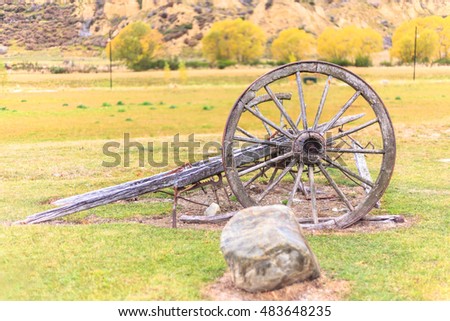 old wooden wagon wheel-autumn background-selective focus