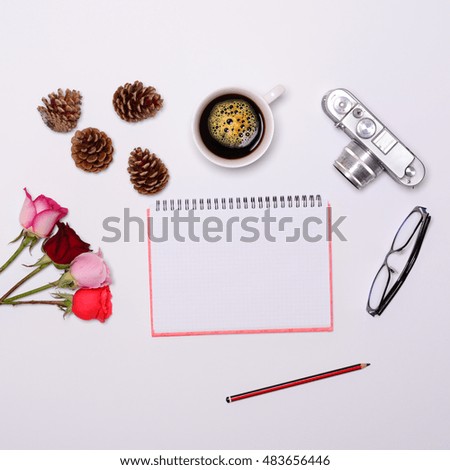 Blank paper with various objcects around it on white background - Trendy minimal flat lay concept