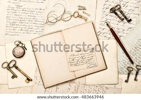 Diary book, vintage accessories, old letters and postcards. Nostalgic background. Retro style toned picture