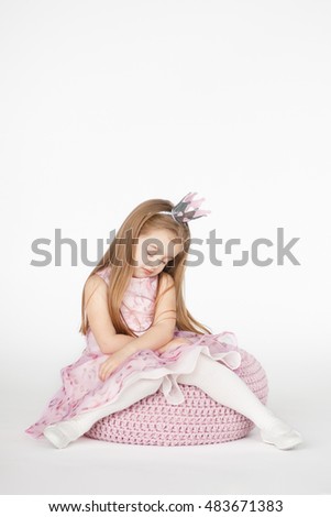 Beautiful girl looking sad and tired. Vertical closeup portrait of cute kid with blond long hair isolated on white background