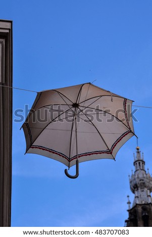 Photo picture of Old umbrella against blue sky