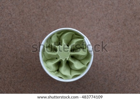 A cup of ice cream, top view. Ice cream is made of pistachio and it is sugar free and gluten free.