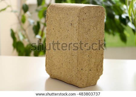 Alternative fuel, eco fuel, bio fuel. Wood sawdust briquettes for stoves. Lean-burn with good heat output. Briquettes from sawdust on a green background.