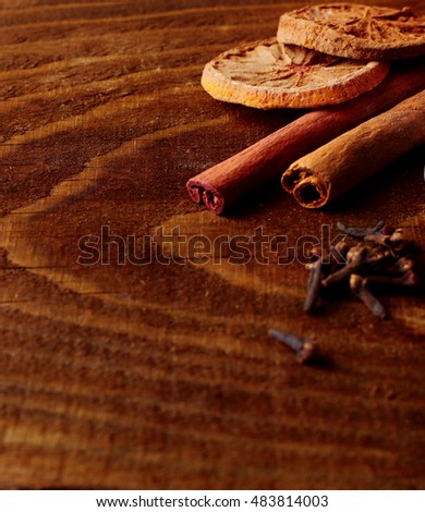 cinnamon sticks dried lemon and carnation defocused on wooden table. Spices.Selective focus