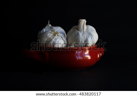 Garlic with kitchen table background in dark food photography style