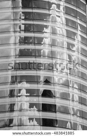 Skyscrapers and clouds reflected in other  skyscrapers. La Defense suburb. (Paris, France). Black and white.
