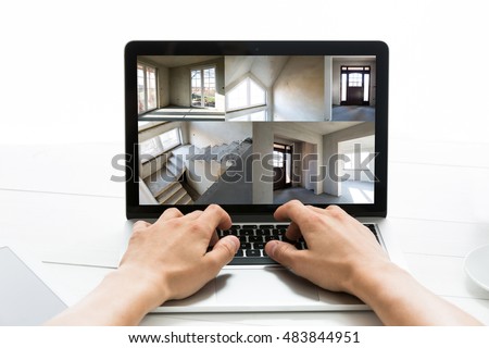 Man watching on a computer online build the house. Concept of monitoring, home security.