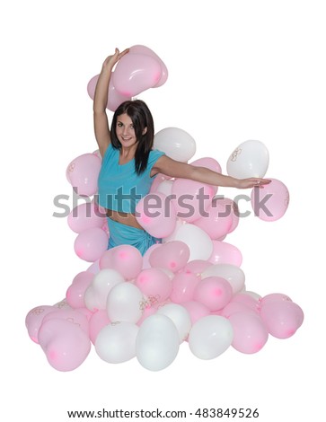 Young beautiful girl rejoices balloons received as a present for his birthday. White isolated background.