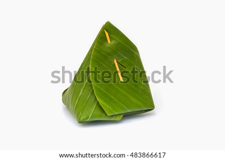 Thai dessert, steaming sticky rice wrapped in banana leave isolated on white background