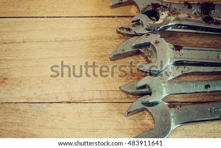 Old wrenches hand tools on wood background vintage and grain picture style
