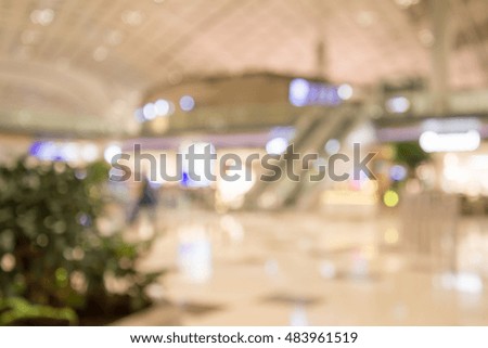 Abstract blur shopping mall in airport terminal for background usage