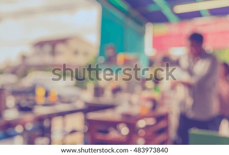 vintage tone blur image of coffee shop with bokeh on day time for background usage .