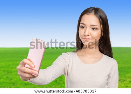 Joyful young women making selfie by her smart phone