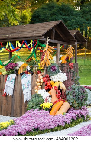 Harvest vegetables on fair trade in a wooden pavilion. Seasonal traditional ukrainian exhibition of farmers achievements. Agricultural products, rural market