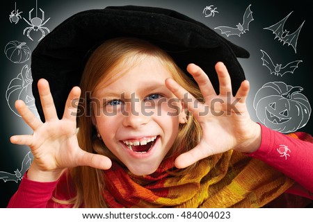 Halloween little girl looking at camera with her hand in frightening gesture