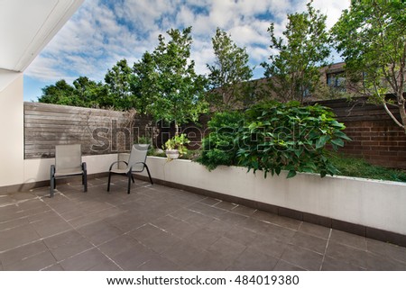 back yard with outdoor seating and barbecue with family
