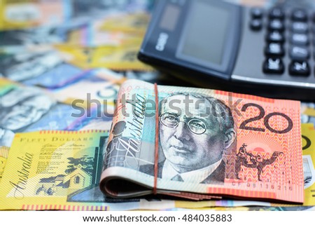 Success and got profit from business with Australia dollar currency,money and calculator,Focus on eye of a man on banknote,copy space