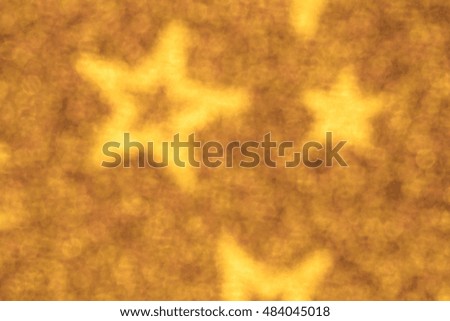 Gift wrap star, golden blurred background.