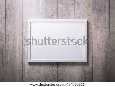 Blank white picture frame on the wood wall