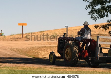 man driving his tractor on the ranch