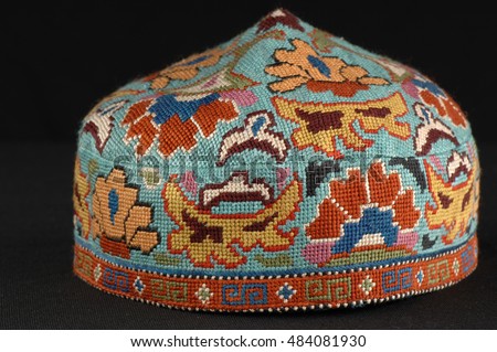 colorful traditional asian skullcap cap on a dark background Royalty-Free Stock Photo #484081930