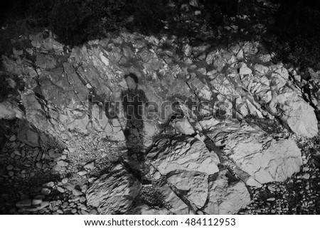 Black and white photo of my own shadow on rocks