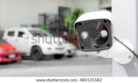 Security equipment concept - CCTV camera video surveillance on pole at car parking guard house safety system area control